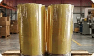 Two large BOPP jumbo tape rolls on a pallet in the UCF warehouse