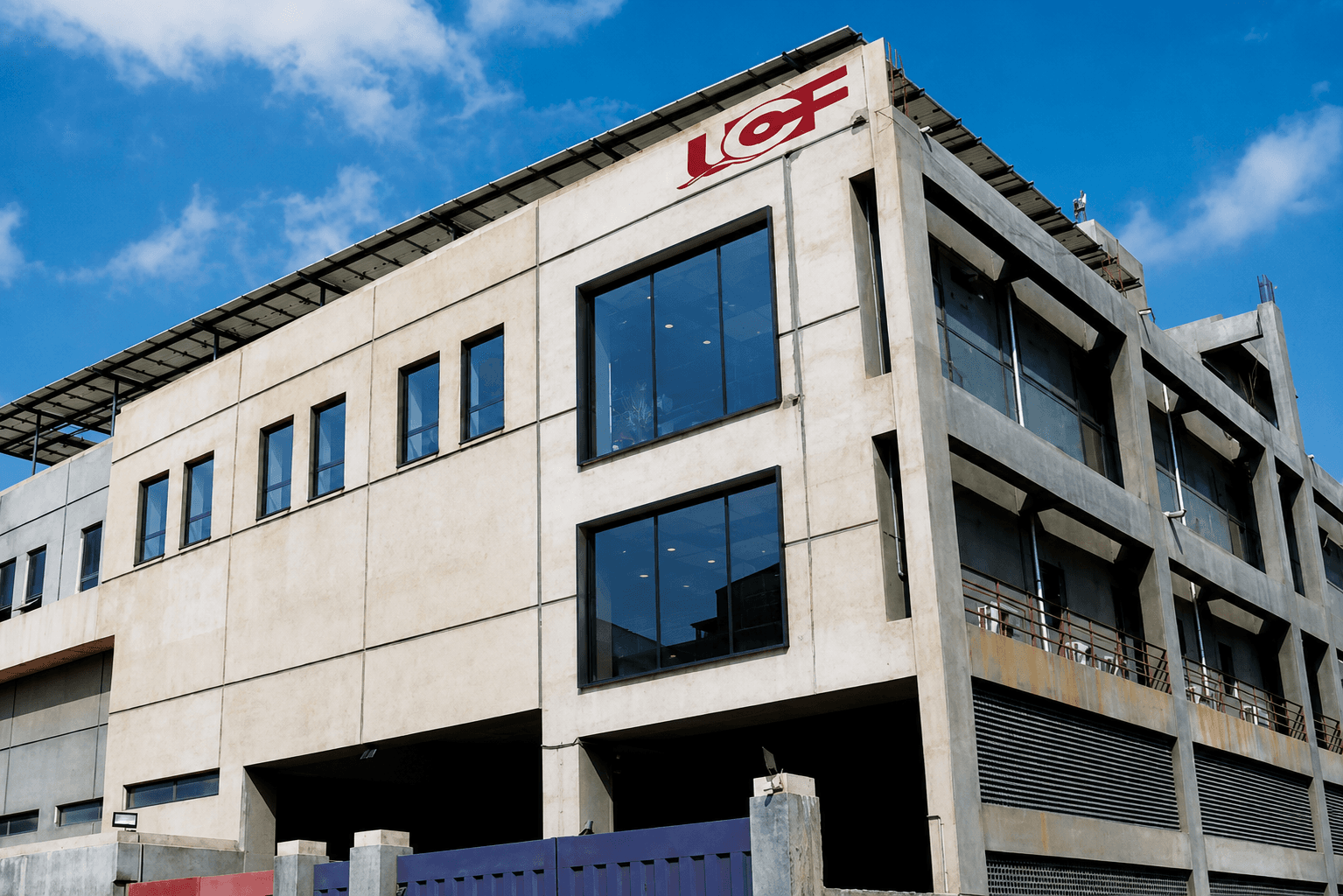 The Universal Coating Films manufacturing facility, with the UCF logo mounted on the roofline